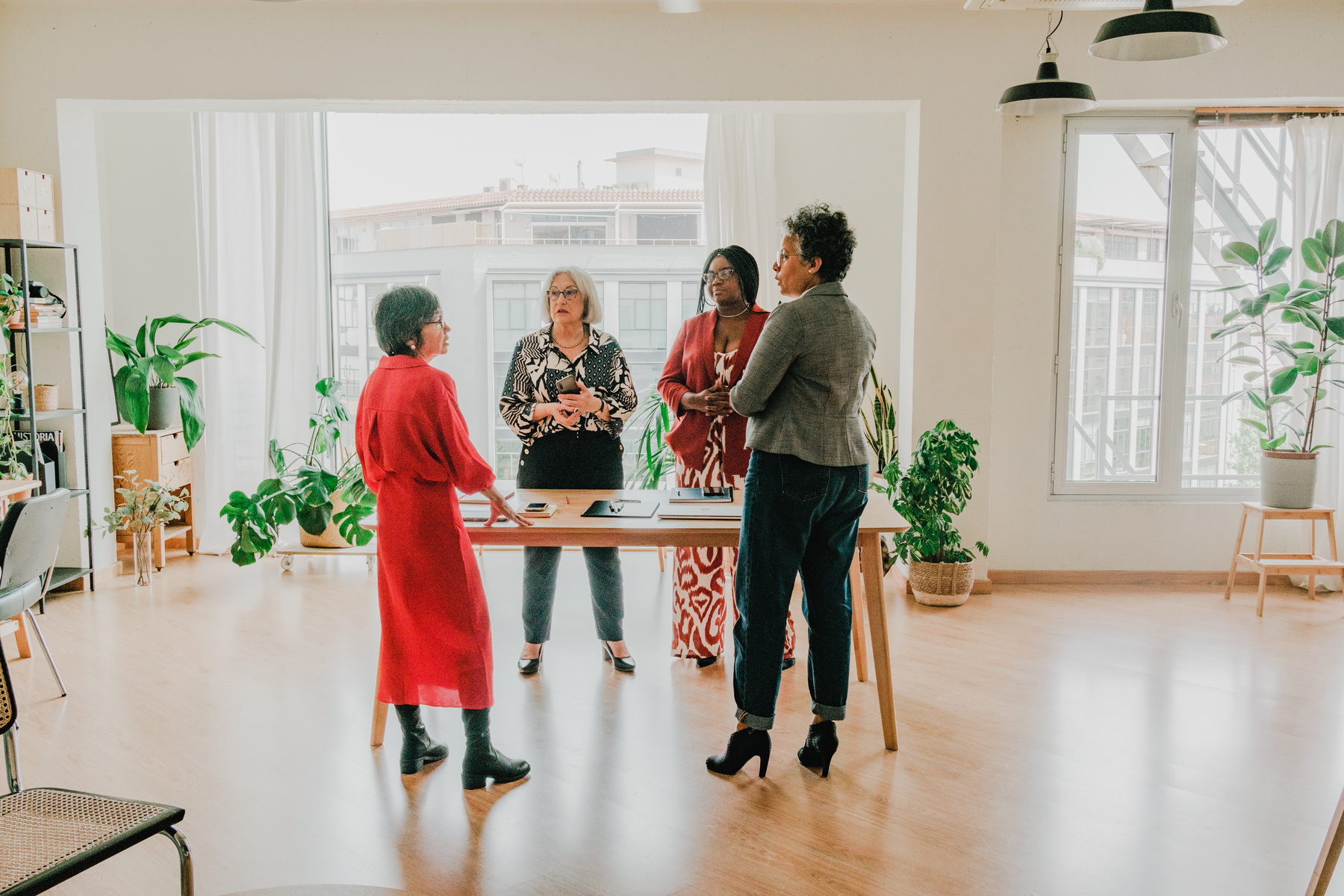 a group of people standing around a table in an office
